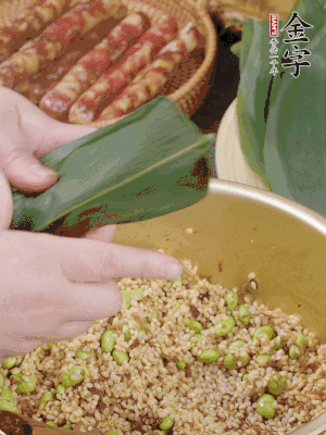 粽葉往下折，完全蓋住，兩側(cè)捏緊。